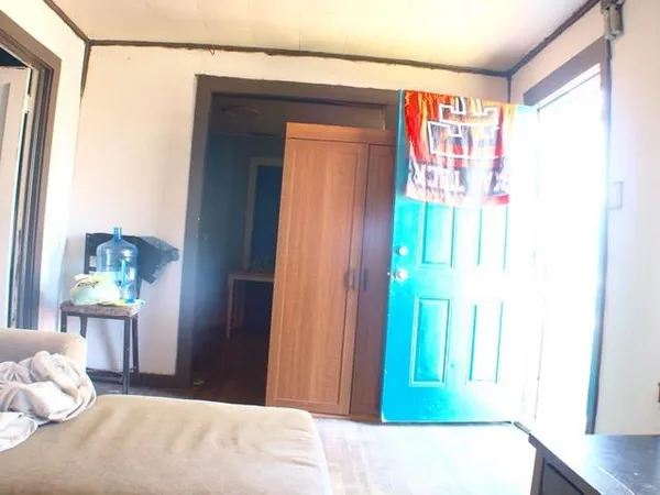 a bedroom with a bed and a window