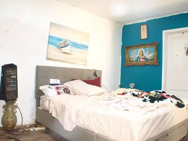 a bedroom with a bed and a flat screen tv