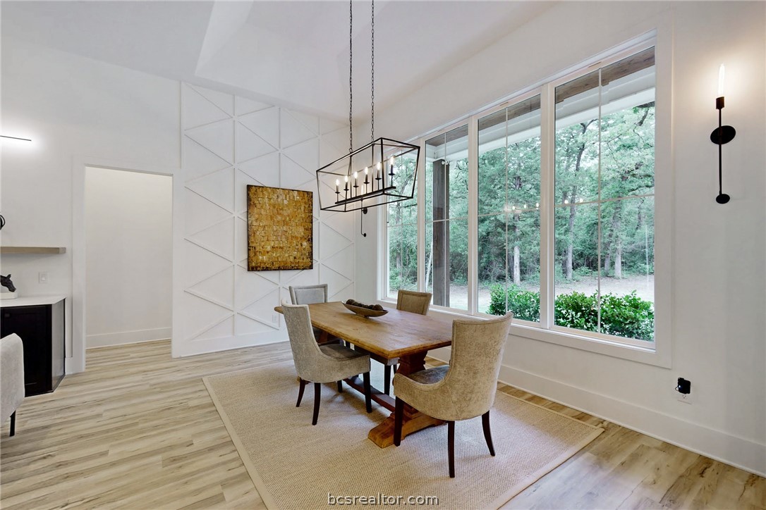 1629 Sawmill Road Franklin, TX 77856 - Photo 14 of 47 a dining room with furniture a chandelier and wooden floor
