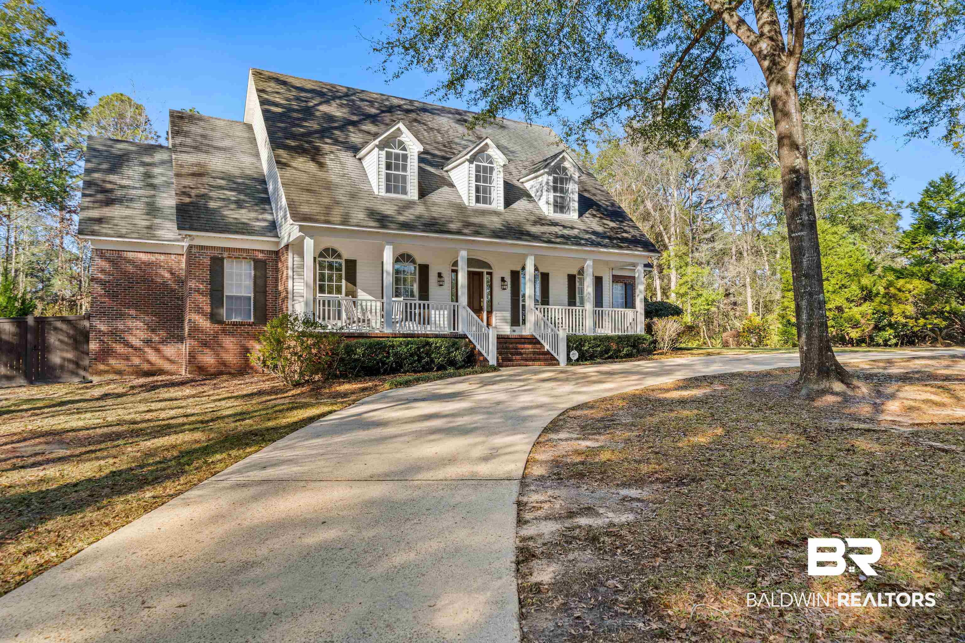 31267 Blakeley Ridge Court Spanish Fort, AL 36527 - Photo 43 of 61 Cape cod home with driveway, brick siding, a porch, and fence