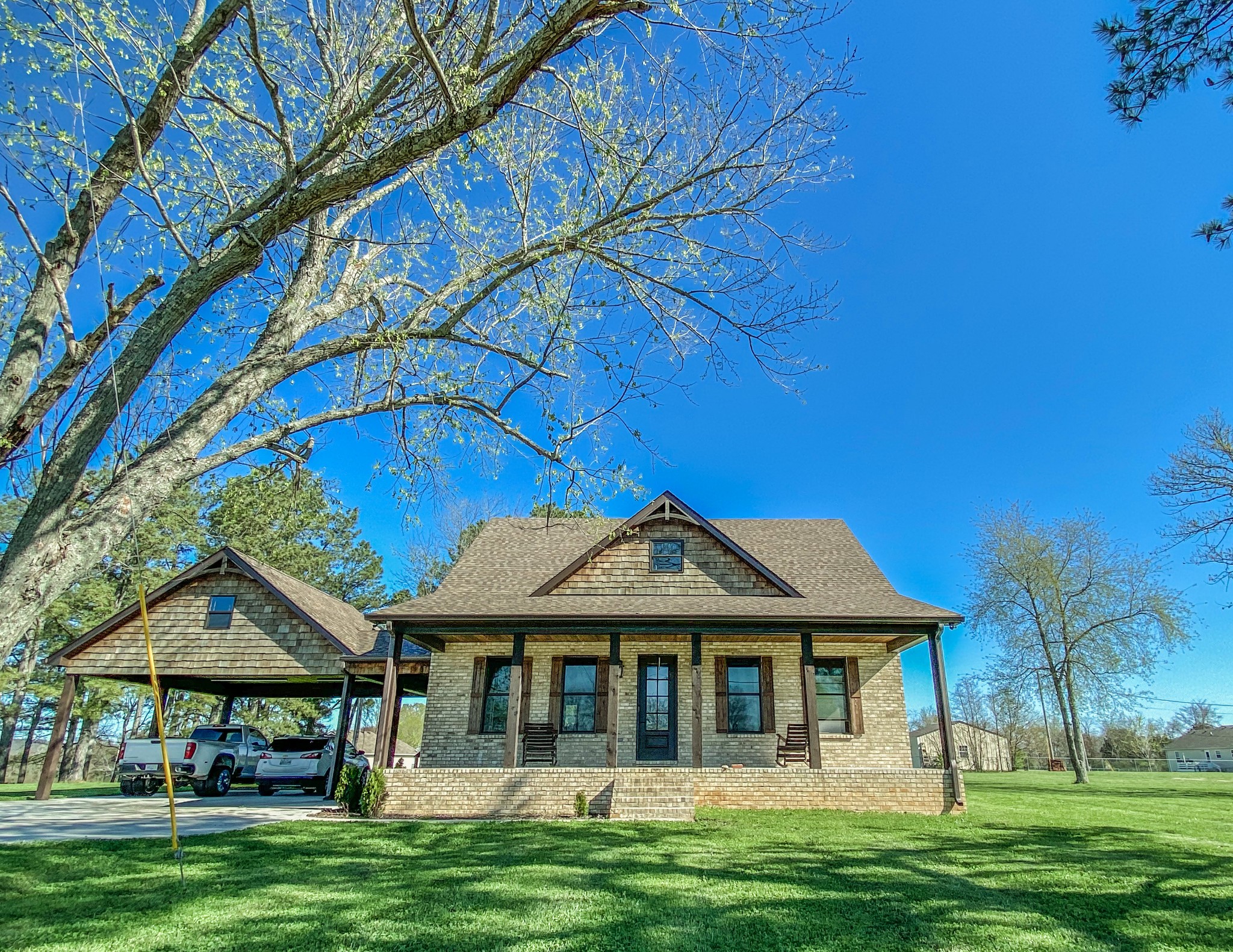 107 Walnut Grove Road Unionville, TN 37180 - Photo 1 of 21 a front view of a house with a garden