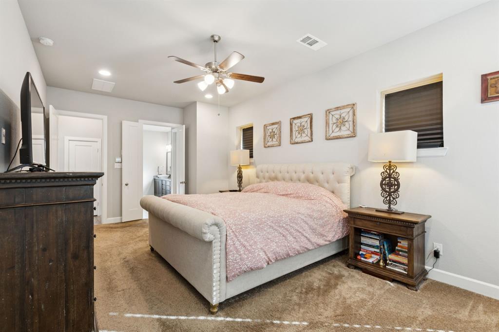 2000 Crescent Street Fort Worth, TX 76008 - Photo 13 of 40 a spacious bedroom with a bed and a chandelier