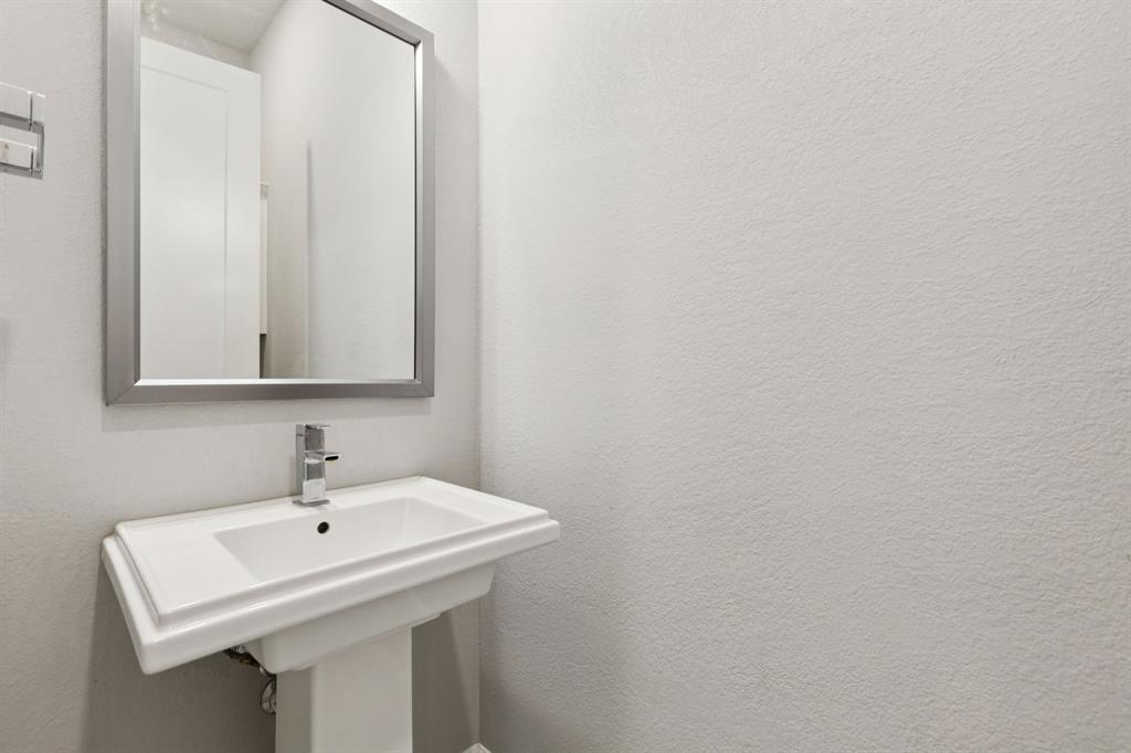2000 Crescent Street Fort Worth, TX 76008 - Photo 22 of 40 a white sink sitting under a bathroom mirror