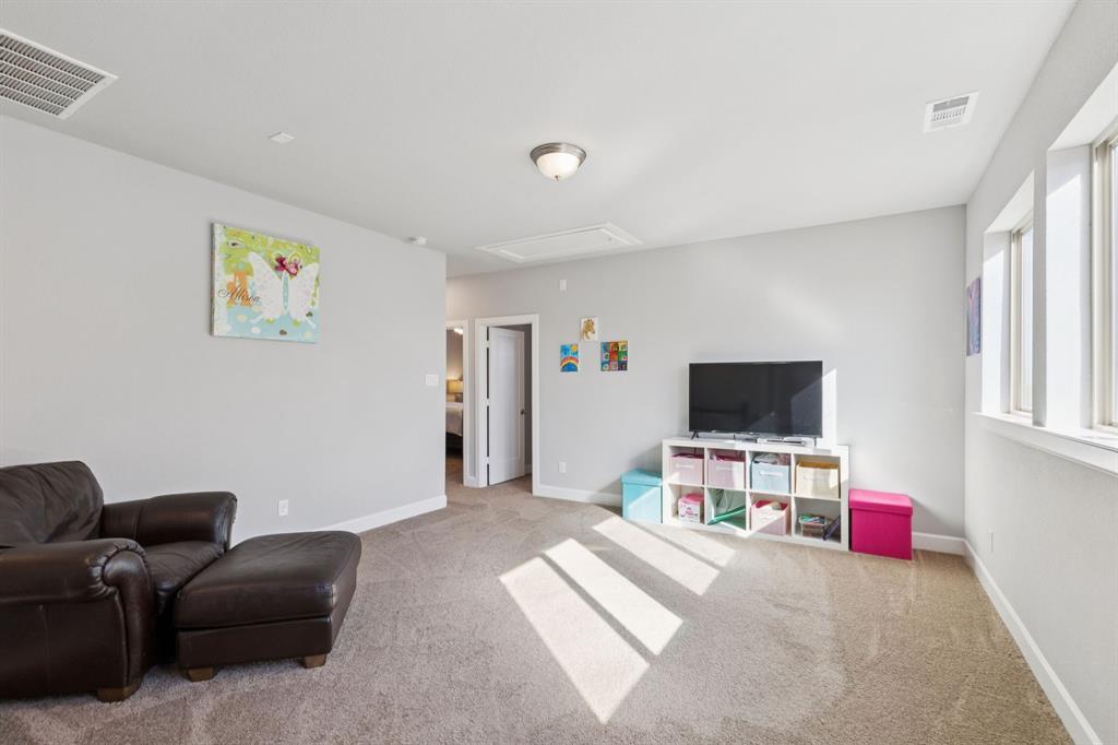 2000 Crescent Street Fort Worth, TX 76008 - Photo 24 of 40 a bedroom with furniture and a flat screen tv