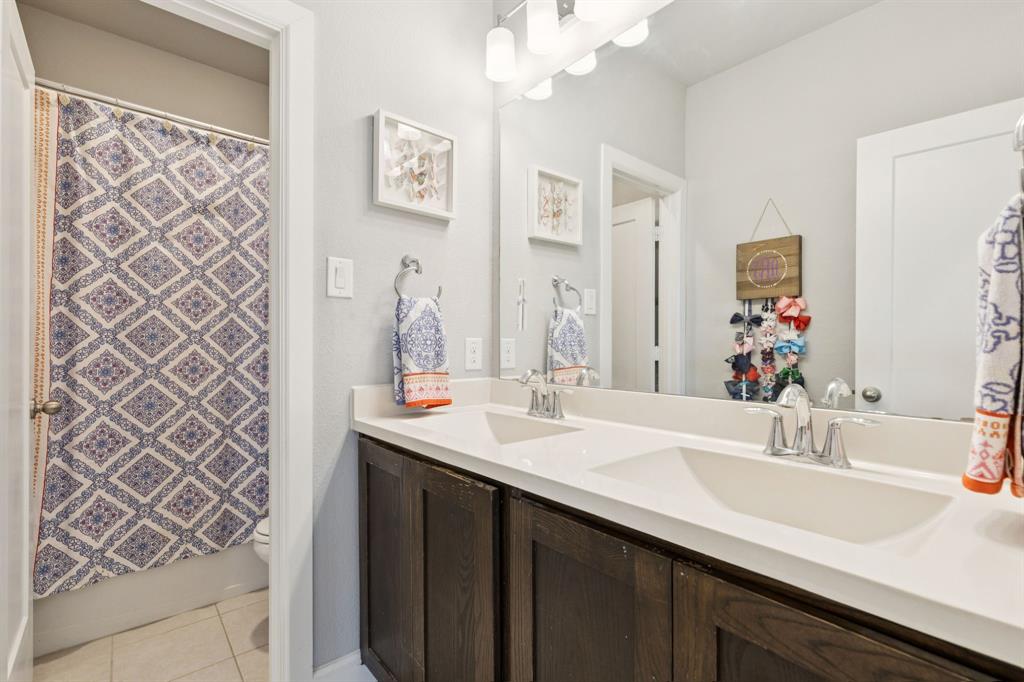 2000 Crescent Street Fort Worth, TX 76008 - Photo 27 of 40 a bathroom with a double vanity sink a mirror and a shower