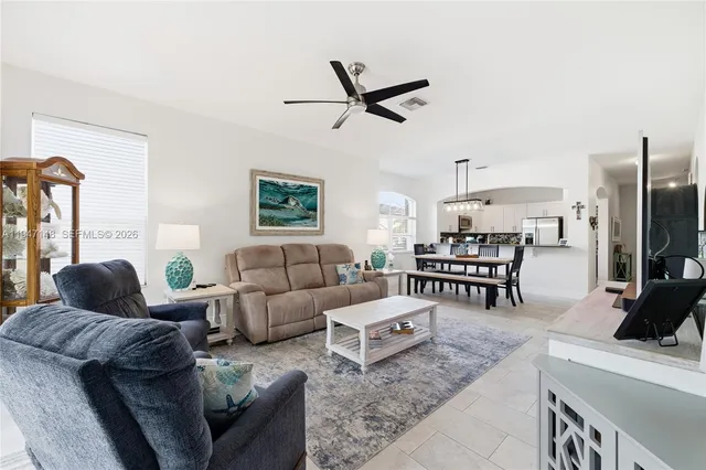 a kitchen with stainless steel appliances granite countertop a refrigerator a stove and a sink