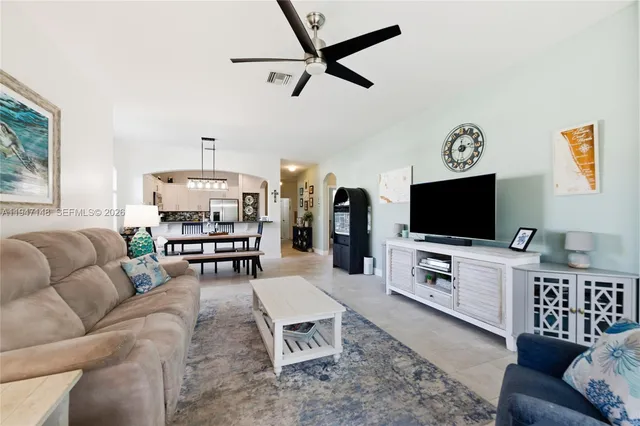 a kitchen with stainless steel appliances granite countertop a refrigerator sink and stove