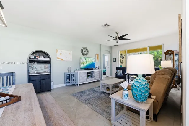 a kitchen with stainless steel appliances granite countertop a sink and dishwasher a refrigerator with white cabinets