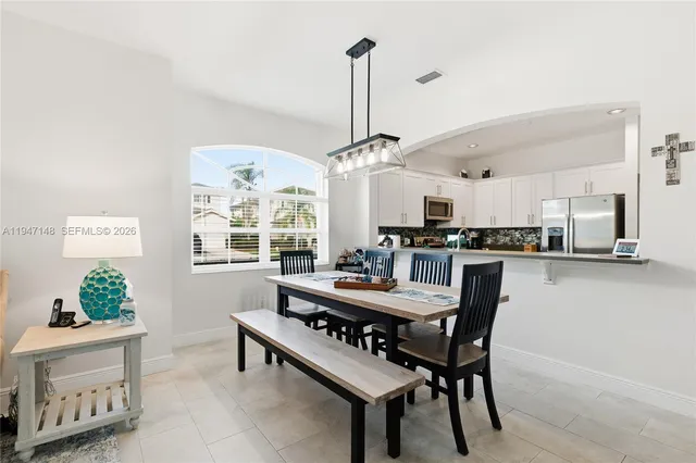 a kitchen with a refrigerator and a stove top oven