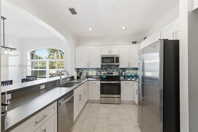 a bedroom with a bed a window and a chandelier