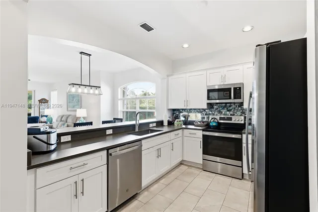 a large bedroom with a bed and a flat screen tv