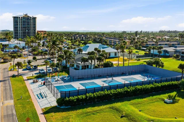 a hallway with dining room and chandelier