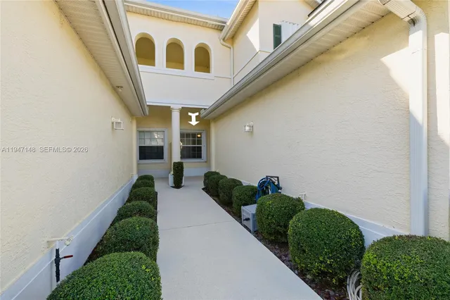 a living room with furniture a flat screen tv and kitchen view