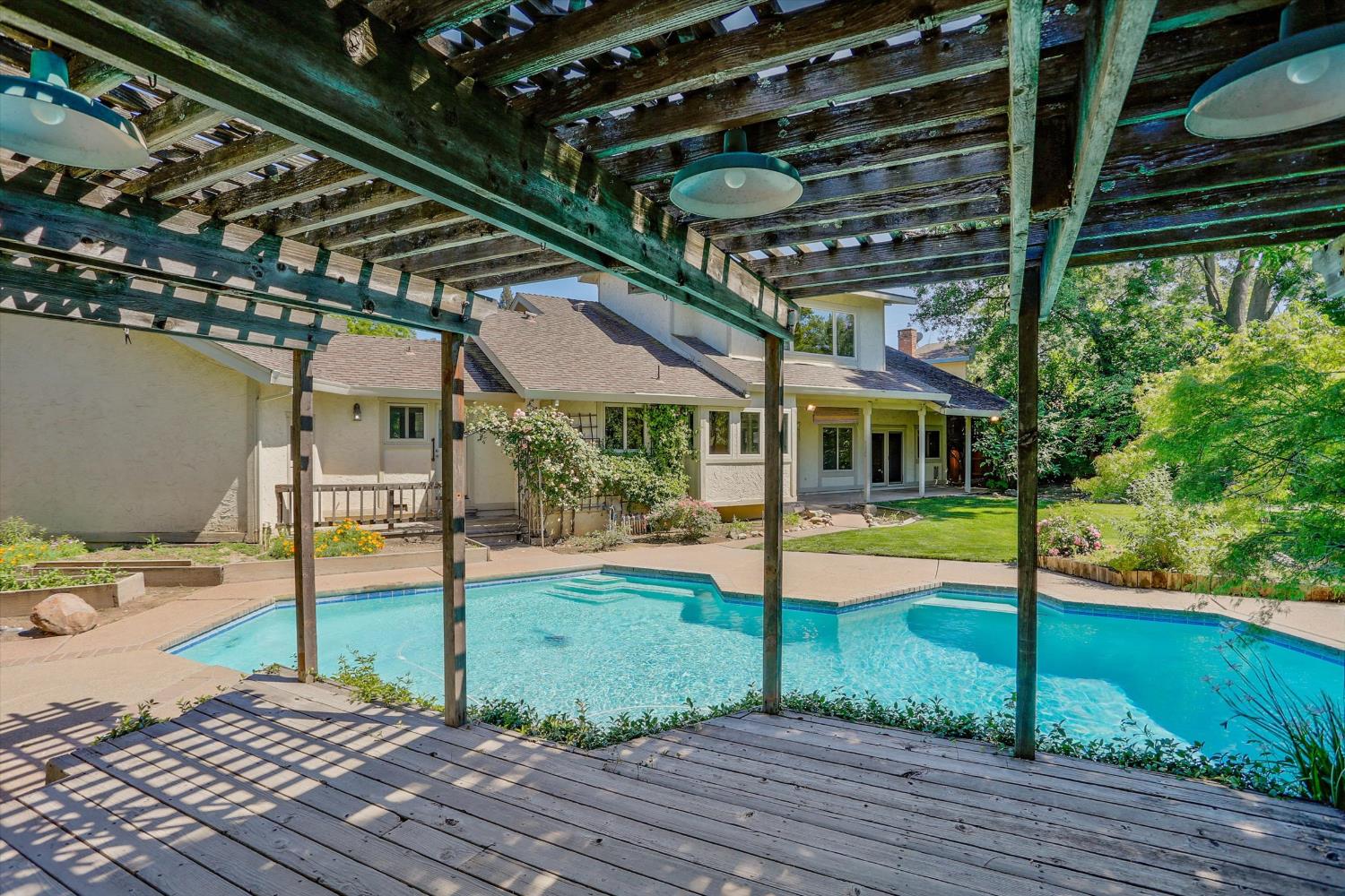 3029 Merrick San Way Carmichael, CA 95608 - Photo 29 of 31 a view of a backyard with table and chairs under an umbrella