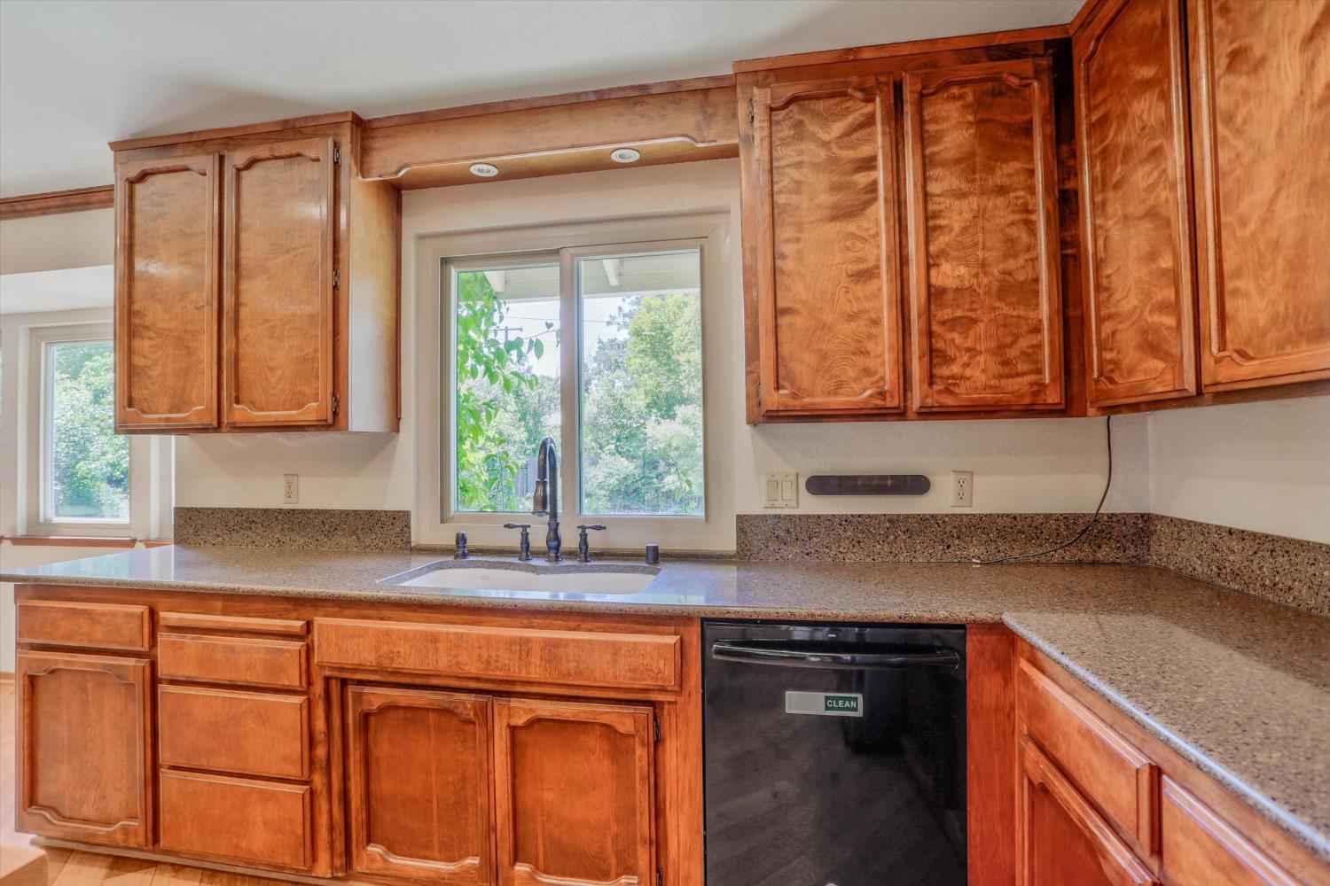 3029 Merrick San Way Carmichael, CA 95608 - Photo 7 of 31 a kitchen with stainless steel appliances granite countertop a sink a stove and next to a window