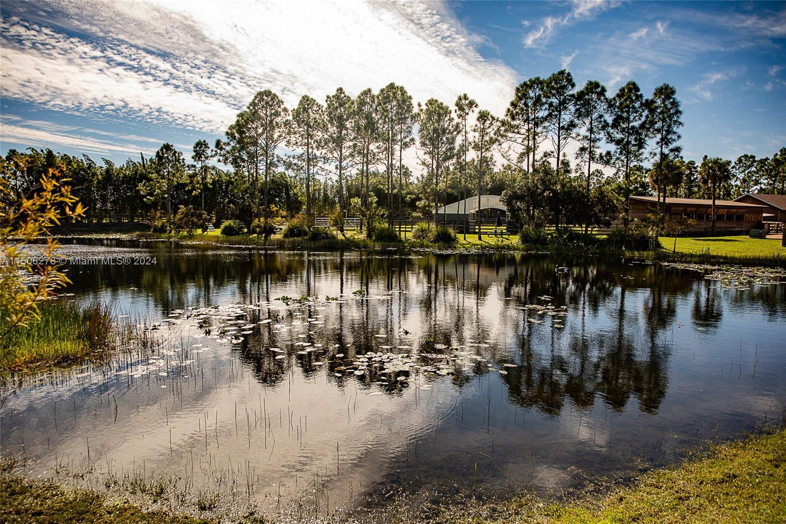 1500 Southeast Ranch Road South Jupiter, FL 33478 - Photo 13 of 29 a view of a lake with boats and trees in the background