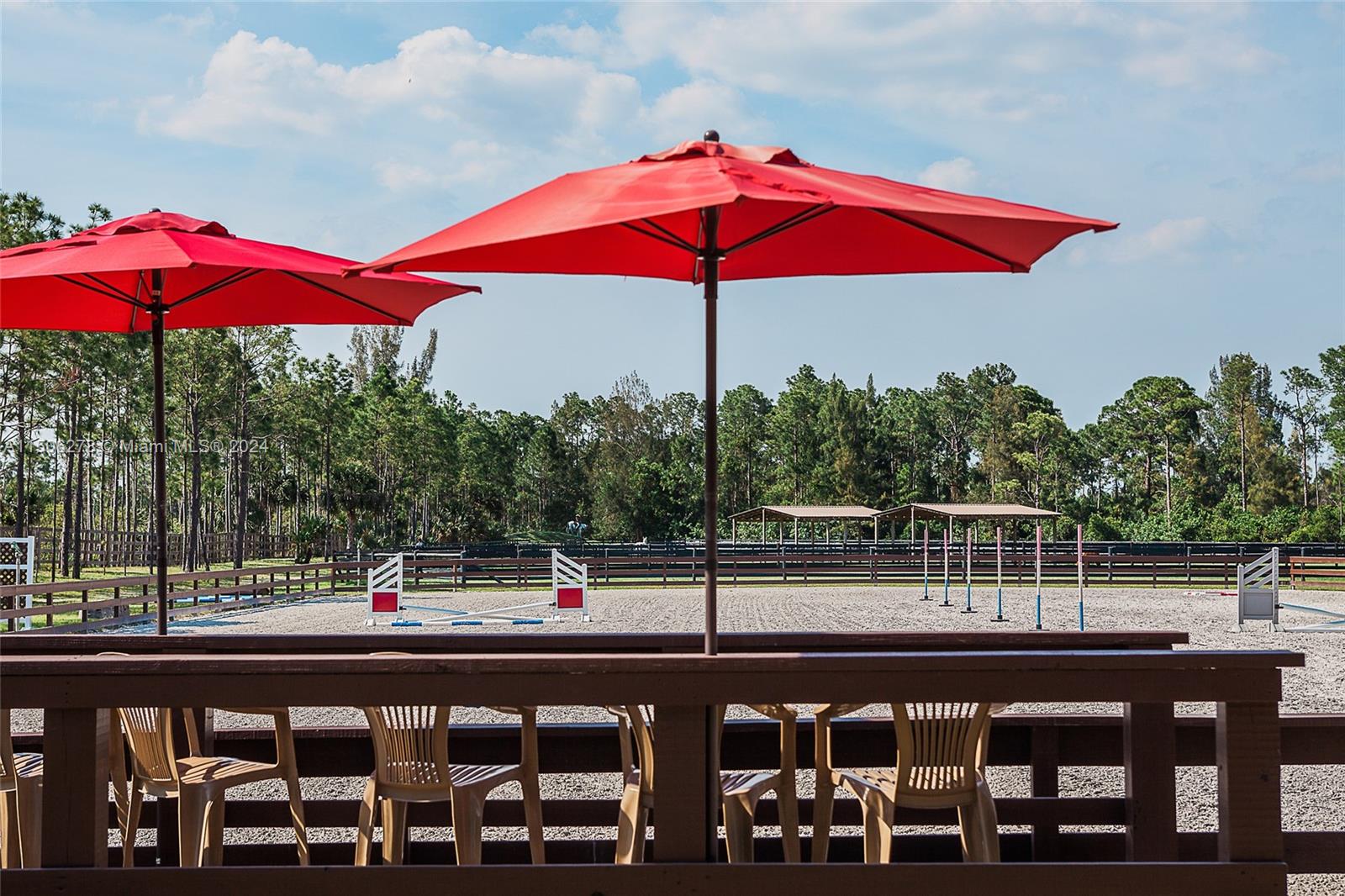 1500 Southeast Ranch Road South Jupiter, FL 33478 - Photo 18 of 29 a view of a swimming pool with a table and chairs under an umbrella