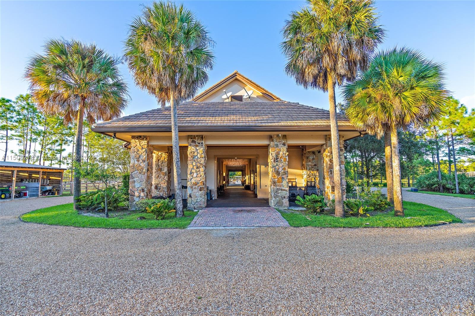 1500 Southeast Ranch Road South Jupiter, FL 33478 - Photo 19 of 29 a front view of a house with garden