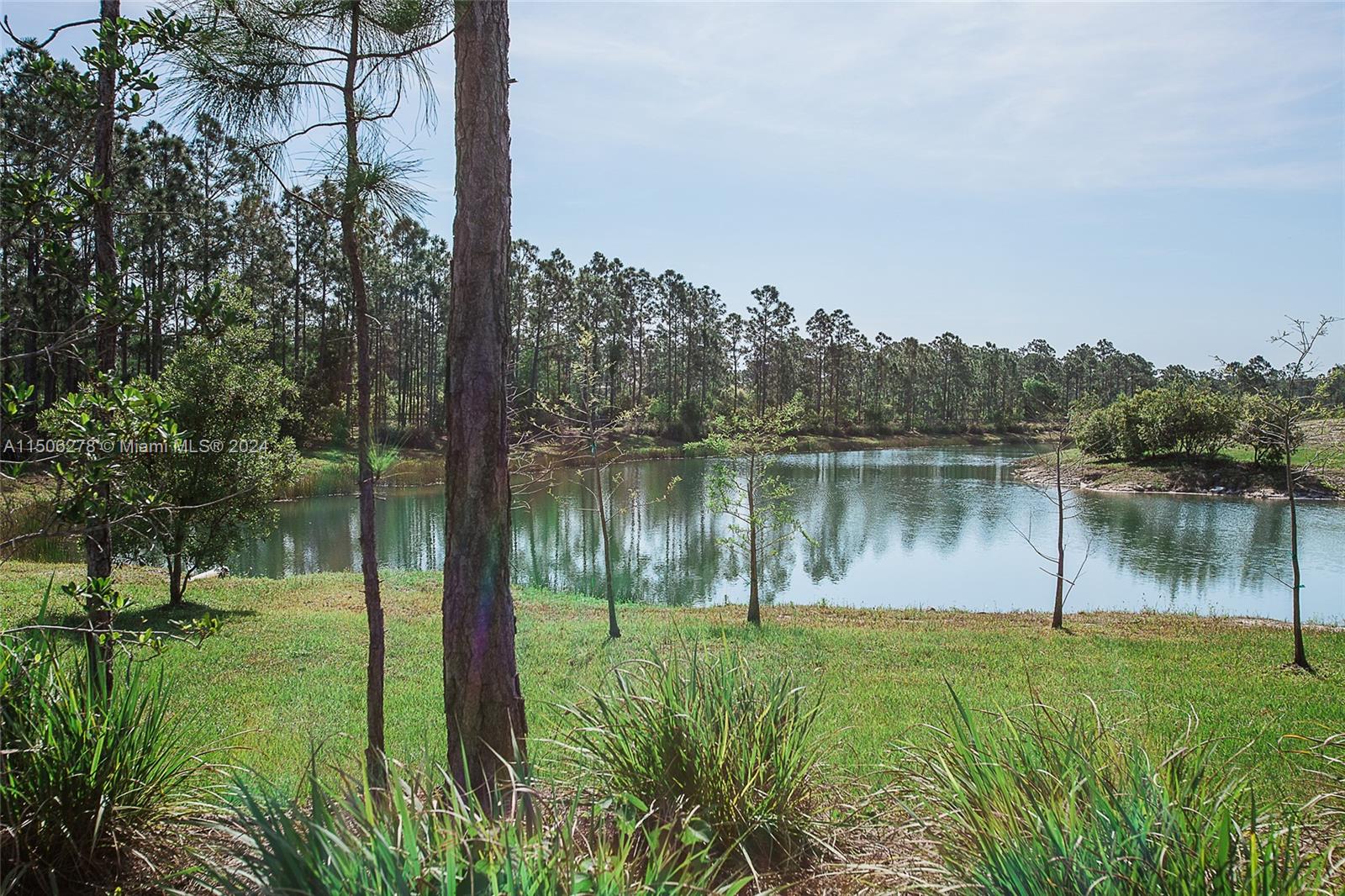 1500 Southeast Ranch Road South Jupiter, FL 33478 - Photo 23 of 29 a view of a lake in between two large trees