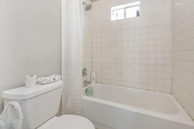 a white bath tub sitting next to a white toilet