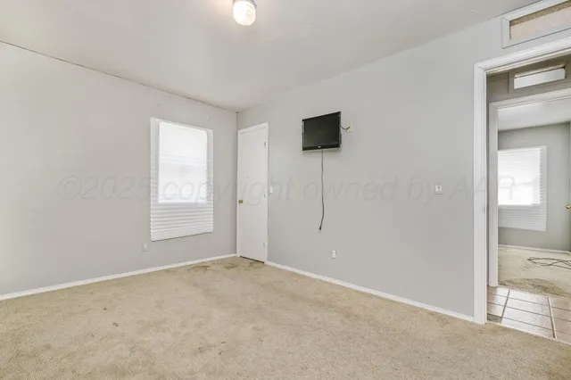 an empty room with windows and closet