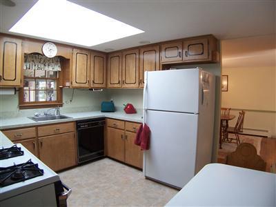 20 Chappaquiddick Road Centerville, MA 02632 - Photo 15 of 22 a kitchen with sink a refrigerator and a stove