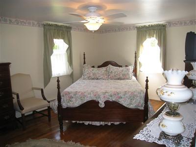 20 Chappaquiddick Road Centerville, MA 02632 - Photo 17 of 22 a bedroom with a bed and a chandelier