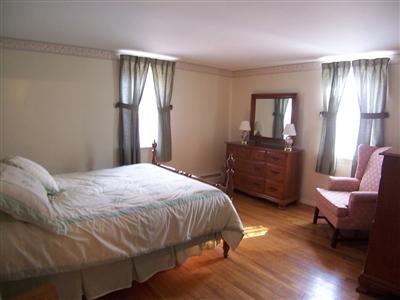 20 Chappaquiddick Road Centerville, MA 02632 - Photo 19 of 22 a bedroom with a bed chair and a window