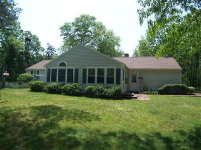 20 Chappaquiddick Road Centerville, MA 02632 - Photo 4 of 22 a front view of a house with a yard and garage