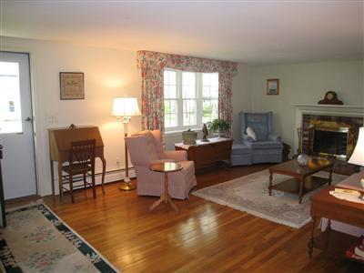 20 Chappaquiddick Road Centerville, MA 02632 - Photo 8 of 22 a living room with furniture a fireplace and a table