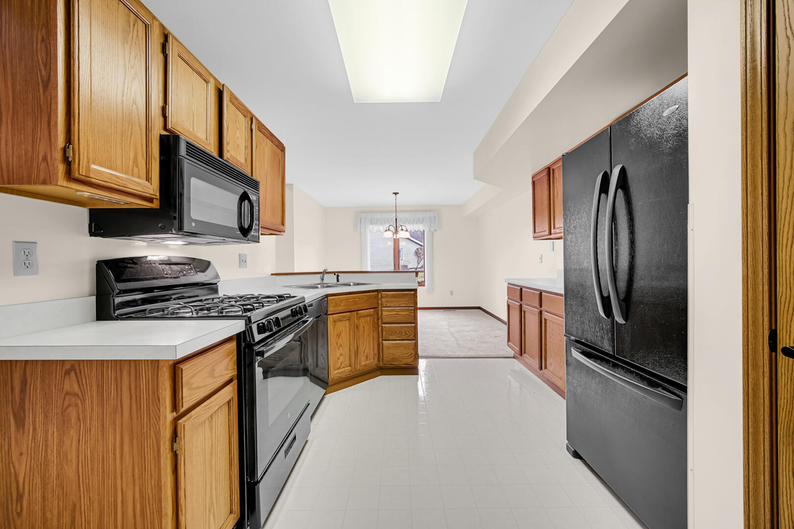 633 West 94th Court Crown Point, IN 46307 - Photo 11 of 29 a kitchen with stainless steel appliances granite countertop a refrigerator stove top oven a sink and dishwasher