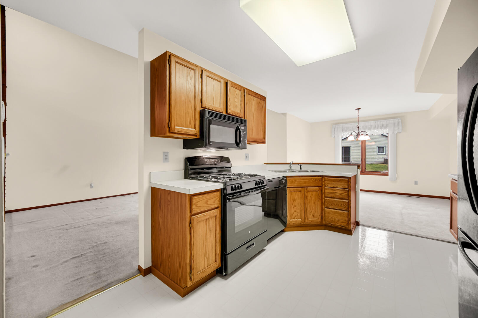 633 West 94th Court Crown Point, IN 46307 - Photo 12 of 29 a kitchen with stainless steel appliances granite countertop a stove a sink and a refrigerator