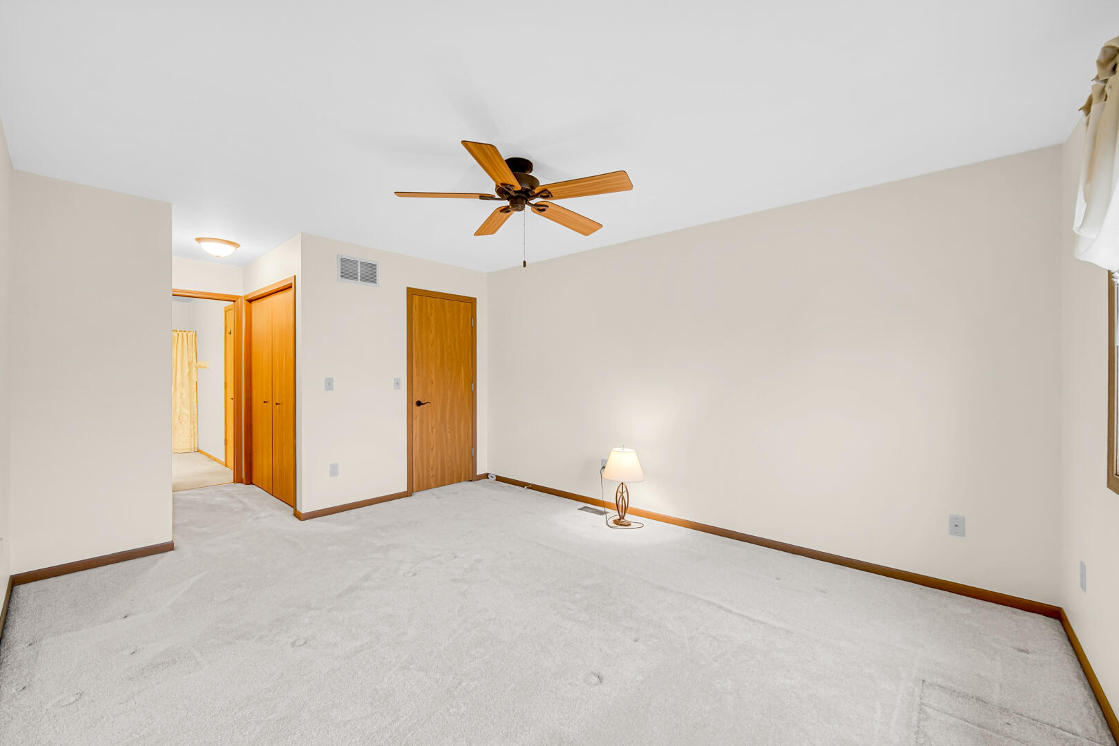 633 West 94th Court Crown Point, IN 46307 - Photo 19 of 29 an empty room with closet and a chandelier fan