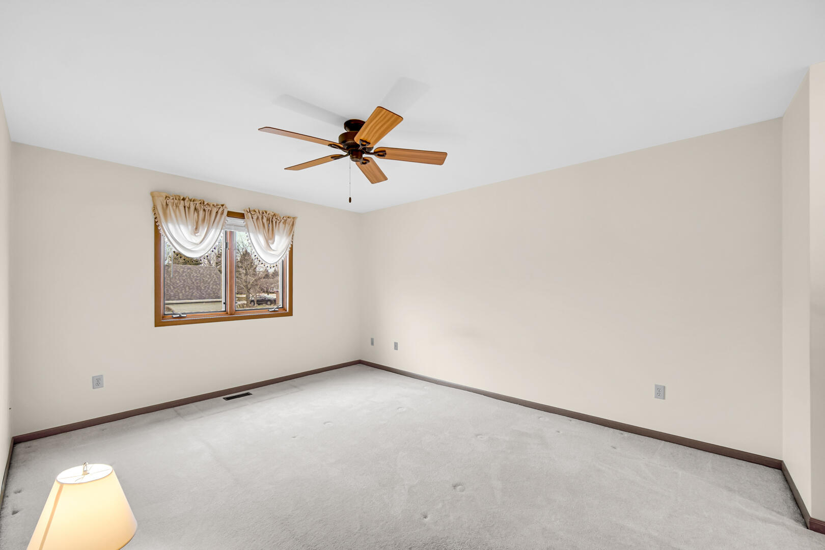 633 West 94th Court Crown Point, IN 46307 - Photo 21 of 29 an empty room with a window and a ceiling fan