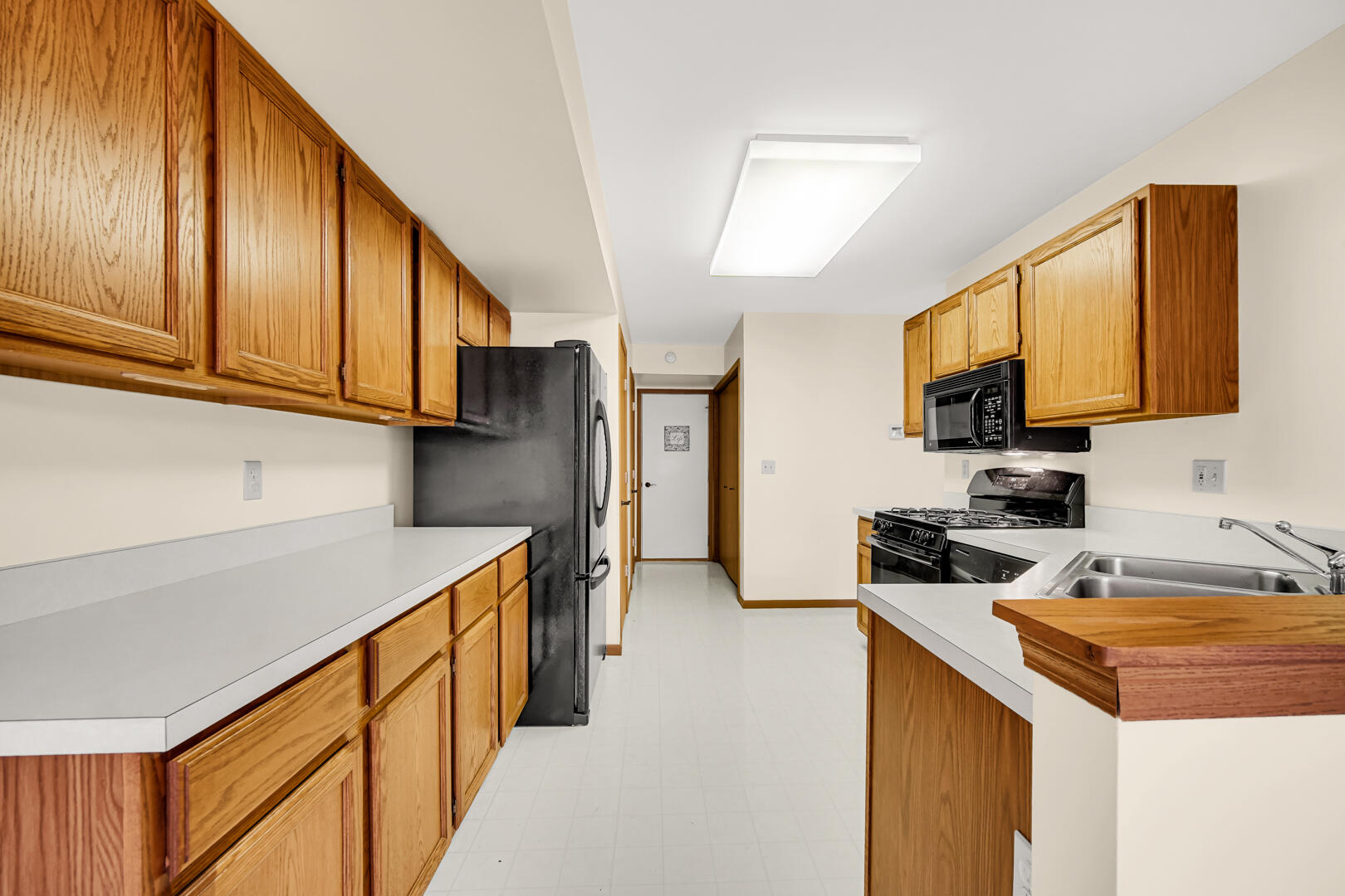 633 West 94th Court Crown Point, IN 46307 - Photo 10 of 29 a kitchen with stainless steel appliances granite countertop a sink stove and refrigerator