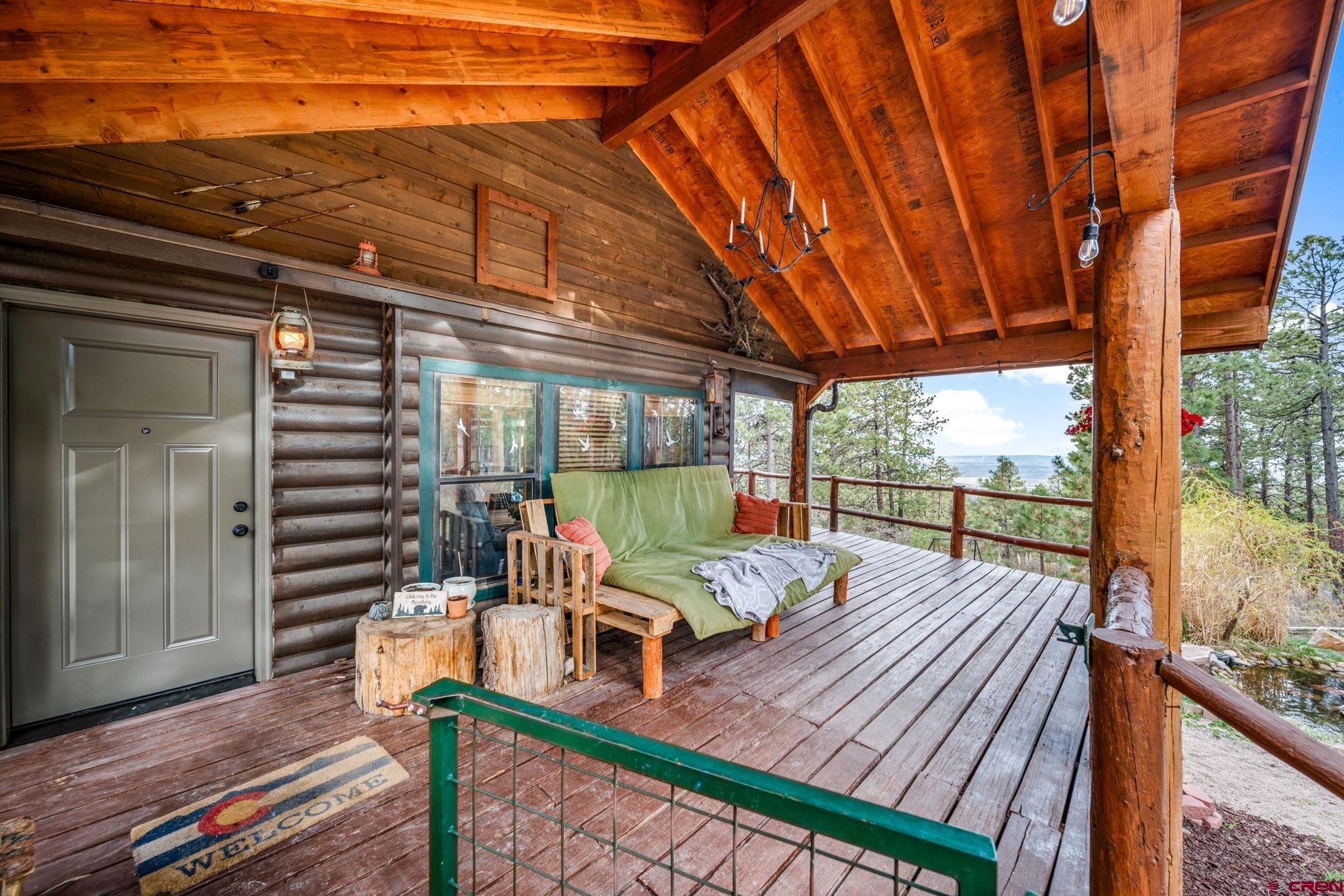 1118 Durango Road Durango, CO 81301 - Photo 11 of 32 a view of a balcony with couch and wooden floor