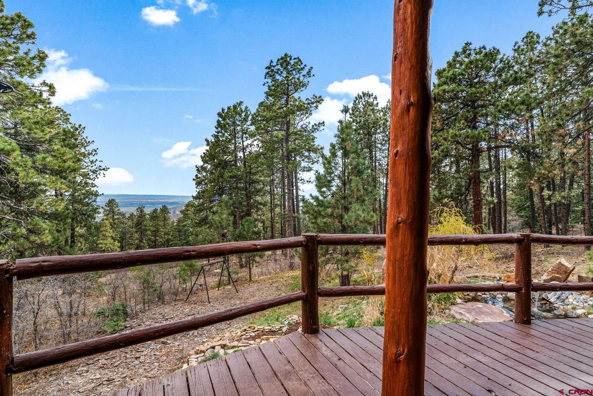 1118 Durango Road Durango, CO 81301 - Photo 13 of 32 a view of balcony with wooden floor and outdoor seating