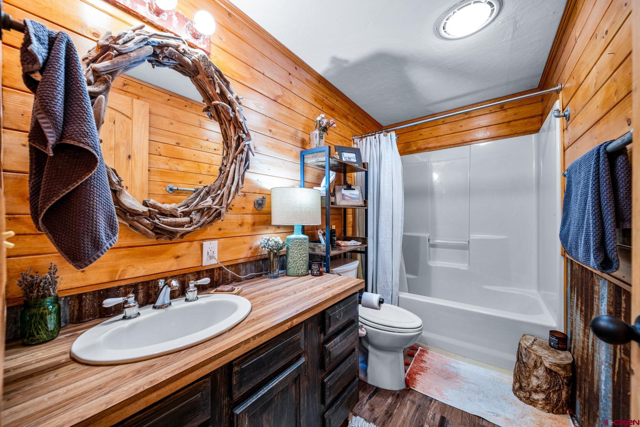 1118 Durango Road Durango, CO 81301 - Photo 18 of 32 a bathroom with a sink a toilet and a mirror