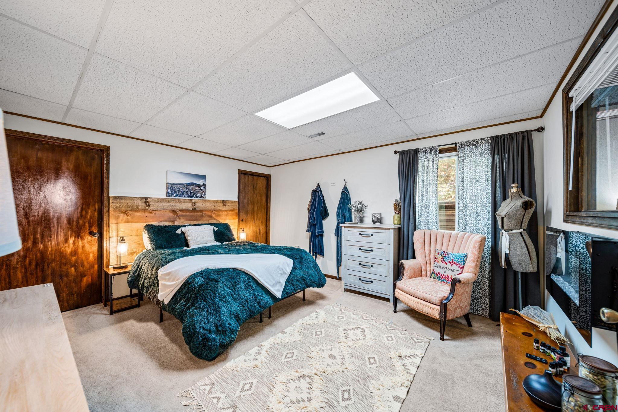 1118 Durango Road Durango, CO 81301 - Photo 25 of 32 a bedroom with furniture and a flat screen tv