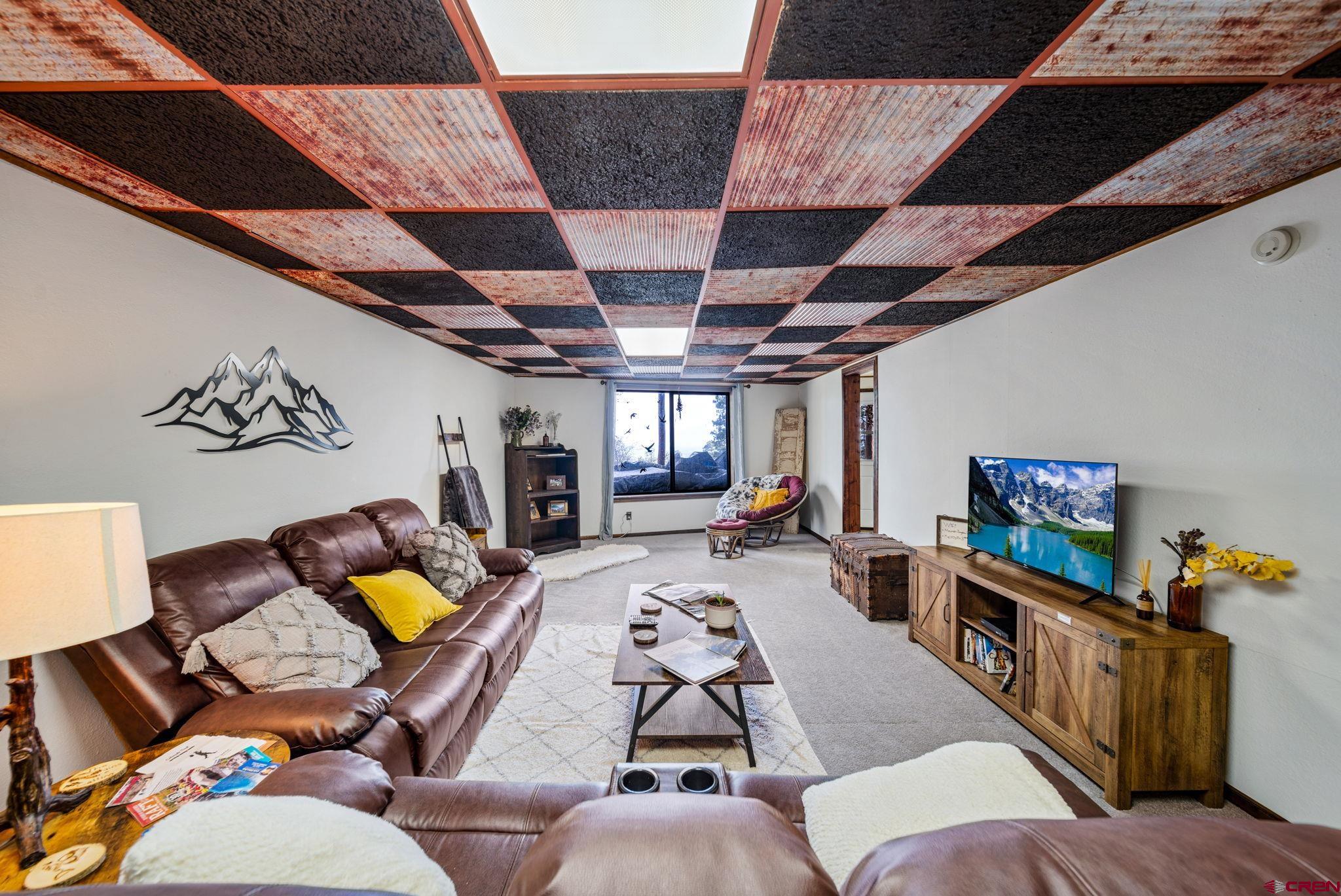 1118 Durango Road Durango, CO 81301 - Photo 26 of 32 a living room with furniture and a flat screen tv