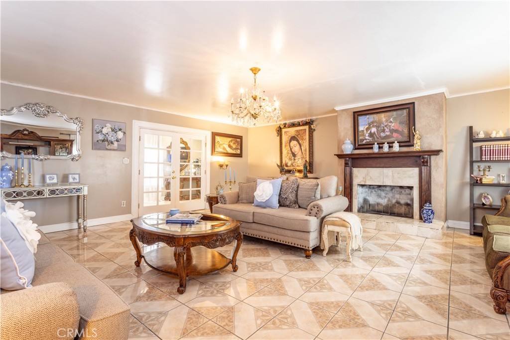 142 North Vendome Street Los Angeles, CA 90026 - Photo 27 of 33 a living room with furniture a fireplace and a chandelier