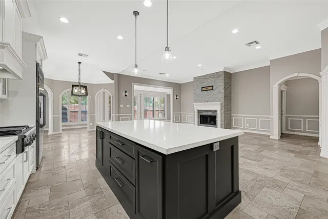 a kitchen that has a lot of cabinets and wooden floor