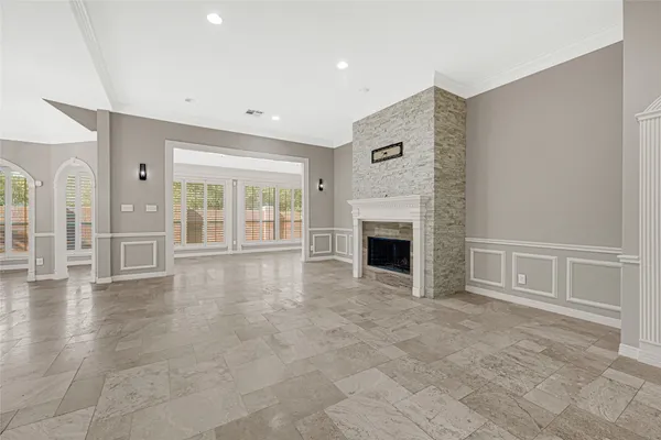 a view of an empty room with a fireplace and a window
