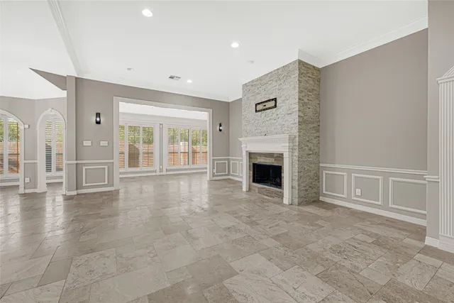 a view of an empty room with a fireplace and a window
