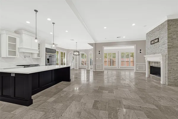 a large hall with stainless steel appliances granite countertop a barbecue grill and cabinets