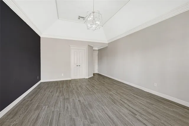 a view of a room with wooden floor and ceiling fan