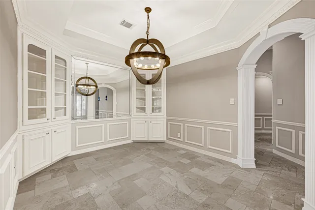 a view of a hallway with chandelier