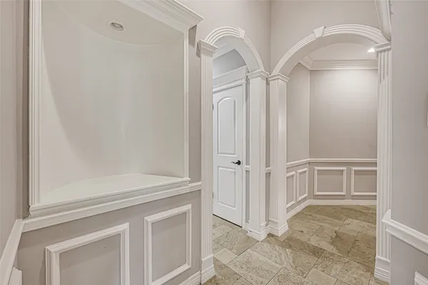 a view of a kitchen with white cabinets and wooden floor