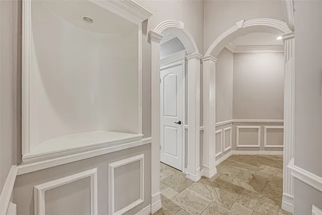 a view of a kitchen with white cabinets and wooden floor