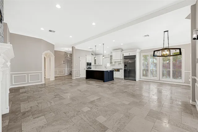 a large white kitchen with a stove and a refrigerator